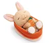 A plush bunny toy with a carrot, nestled in a peach-colored basket. Produktbild-Vorschau