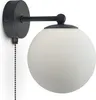 A black wall-mounted light fixture with a white glass globe. Podgląd zdjęcia produktu