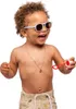 A young child wearing sunglasses and shorts is blowing bubbles. Voir les images du produit