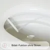 Close-up view of a bidet attachment on a toilet seat, with water spraying from the nozzle. Produktbild-Vorschau