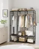 A well-organized open wardrobe with clothes hanging and items stored on shelves. Náhled obrázku produktu