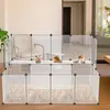 A modular pet enclosure with three small animals inside, set up in a room with furniture. Produktbild-Vorschau