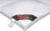 A close-up view of a white down comforter with a label attached. Produktbild-Vorschau