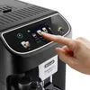 A hand is shown pressing a button on the touch screen of a black DeLonghi coffee machine. Produktbild-Vorschau