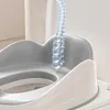 A close-up view of a child's toilet seat with a step stool attachment. A translucent blue spine graphic is superimposed over the seat. Produktbild-Vorschau
