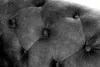 A close-up view of a tufted armchair's upholstery. Produktbild-Vorschau