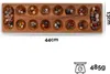 A wooden board game with colorful stones in its pits, along with dimensions and weight information. Produktbild-Vorschau