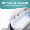 A marketing image showing a white bath mat with dimensions indicated, placed next to a bathtub filled with water. Produktbild-Vorschau