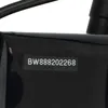 A close-up of a black product with a serial number sticker. Produktbild-Vorschau