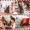 A collage of four images showcasing a small Christmas tree decoration with red berries and pine cones in a log-like vase, presented in various home settings. Produktbild-Vorschau