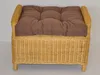 A close-up, front-facing view of a wicker ottoman with a brown cushion. Produktbild-Vorschau