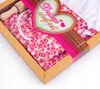 A close-up view of a children's chef set packaged in a cardboard box. Produktbild-Vorschau