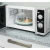 A microwave with its door open, showing a plate with food inside, covered by a clear lid. Anteprima dell’immagine prodotto