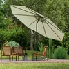 An outdoor patio scene with a table, chairs, and a large umbrella. Produktbild-Vorschau