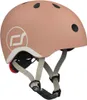 A pink helmet with white accents and straps is shown against a white background. Náhľad obrázku produktu