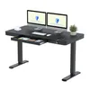 A black electric height-adjustable desk with two monitors, a keyboard, a mouse, a cup, a plant, and an open drawer. Náhled obrázku produktu