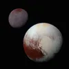Two celestial bodies, Pluto and Charon, against a black background. Produktbild-Vorschau