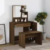 A vanity table with a mirror and stool, set up in a room with a potted plant and a framed picture. Náhľad obrázku produktu