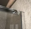 Close-up of a shower door track and roller mechanism against a tiled wall. Produktbild-Vorschau