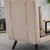 A close-up view of the back of a beige upholstered sofa or chair, showing stitching details and a black metal leg. Náhľad obrázku produktu