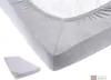 A close-up view of a fitted sheet on a mattress. Produktbild-Vorschau