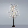 A decorative LED tree with white lights on a dark stand against a light gray background. Podgląd zdjęcia produktu