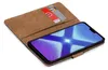 A brown book-style phone case with a phone inside, showing a blue and white abstract wallpaper on the screen. Two cards are visible in a slot on the inside cover. Anteprima dell’immagine prodotto