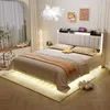 A bedroom scene featuring a bed with LED lighting, decorative pillows, and a bedside table. Náhled obrázku produktu