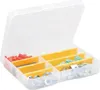 A transparent plastic organizer box with yellow dividers, filled with various small hardware items like red and green plastic connectors, and metal washers and screws. Voir les images du produit