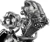 A close-up view of a metal sculpture of a wedding couple on a tractor, holding flowers. Produktbild-Vorschau