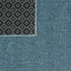 A close-up view of a blue rug, showing the texture of the fabric and the patterned backing. Produktbild-Vorschau