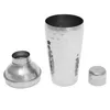 A disassembled stainless steel cocktail shaker is laid out on a white background. The shaker consists of a main body, a strainer top, and a small cap. Anteprima dell’immagine prodotto