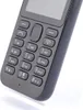 A close-up shot of a black Nokia 222 feature phone, focusing on the keypad and screen. Produktbild-Vorschau