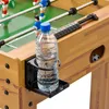 A close-up of a foosball table with a water bottle in a cup holder. Podgląd zdjęcia produktu