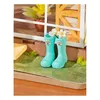 A miniature scene with a pair of turquoise rain boots filled with white flowers, placed on a green grassy surface in front of a window. Anteprima dell’immagine prodotto