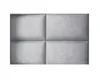 A close-up, flat lay view of four gray upholstered wall panels arranged in a 2x2 grid. Produktbild-Vorschau