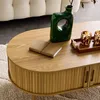 A close-up of a wooden coffee table with decorative items on it. Produktbild-Vorschau