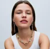A woman wearing a white tank top and Pandora charms necklace and earrings. Náhľad obrázku produktu