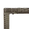 A close-up view of the corner of a grey rattan furniture piece, showing the woven texture and a connection point. Voir les images du produit
