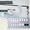 A close-up view of a white window frame with a white pleat blind attached using a clamp system. Various accessories for the blind are laid out below. Produktbild-Vorschau