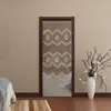 A beaded curtain hangs in a doorway, reflecting a mirror. A vase with branches and flowers is to the right, and part of a bed is visible on the left. Podgląd zdjęcia produktu