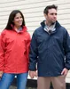 A man and a woman are standing next to each other, holding hands, and looking to the side. They are both wearing jackets. Podgląd zdjęcia produktu