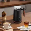 A black milk frother with a wood-grain handle and base, set on a wooden table with a cup of coffee, a glass of iced tea, and a piece of bread. Produktbild-Vorschau