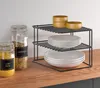 A kitchen counter with storage jars and a corner shelf unit holding plates and bowls. Produktbild-Vorschau