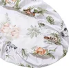 A close-up view of a white fitted sheet with a savanna-themed print of animals and leaves. Produktbild-Vorschau