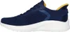 A side view of a blue Skechers Bobs Squad Chaos training shoe with yellow accents. Náhled obrázku produktu