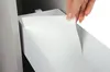 A hand is shown placing a white textured sheet into a white drawer or cabinet. Voir les images du produit