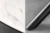 A close-up split image showing the marble-patterned surface of a table on the left and a black metal table leg on the right. Produktbild-Vorschau