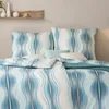 A bed with bedding and pillows. Produktbild-Vorschau