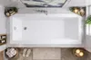 A top-down view of a modern bathroom with a white bathtub as the central focus, surrounded by marble tiles and decorative elements. Produktbild-Vorschau
